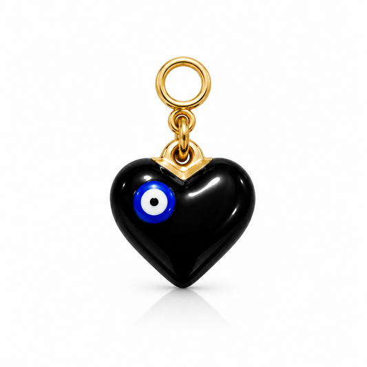 A black heart-shaped charm with a blue and white evil eye detail and a gold-tone loop at the top, shown on a clean white background.