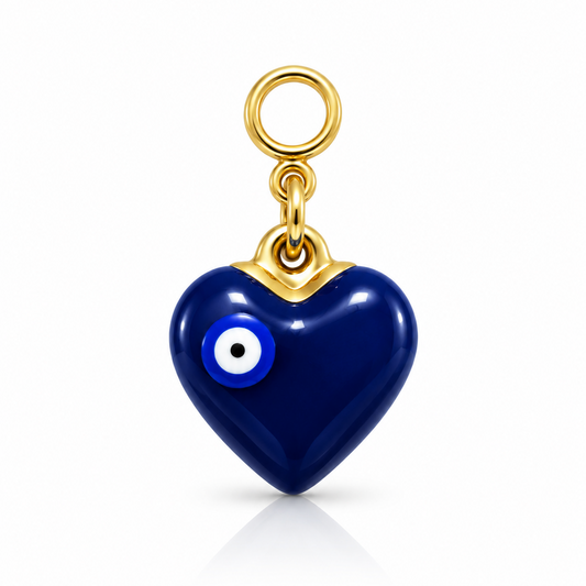 A heart-shaped evil eye pendant charm in glossy dark blue with gold-tone metal framing and a gold ring loop at the top, shown on a clean white background.