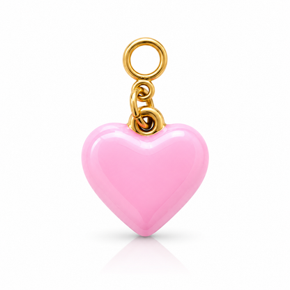 A glossy pink heart-shaped charm with a gold-tone metal loop and chain, shown on a clean white background with a soft reflection below.