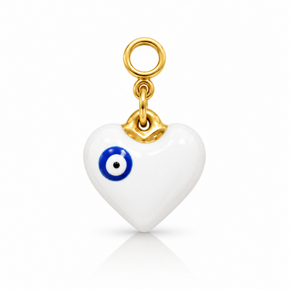 A white heart-shaped charm pendant with a blue and white evil eye design, attached to a gold bail and hanging loop, shown on a clean white background.