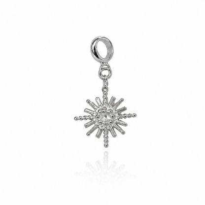 Silver sun-shaped charm on a white background